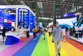 Man walking in an International Serminar Event on rainbow colored floor